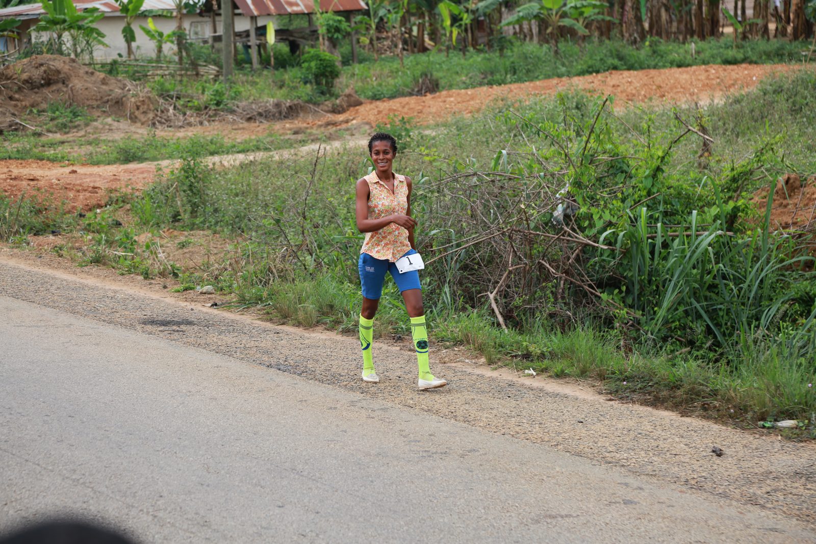 A runner in bright knee socks on the open road