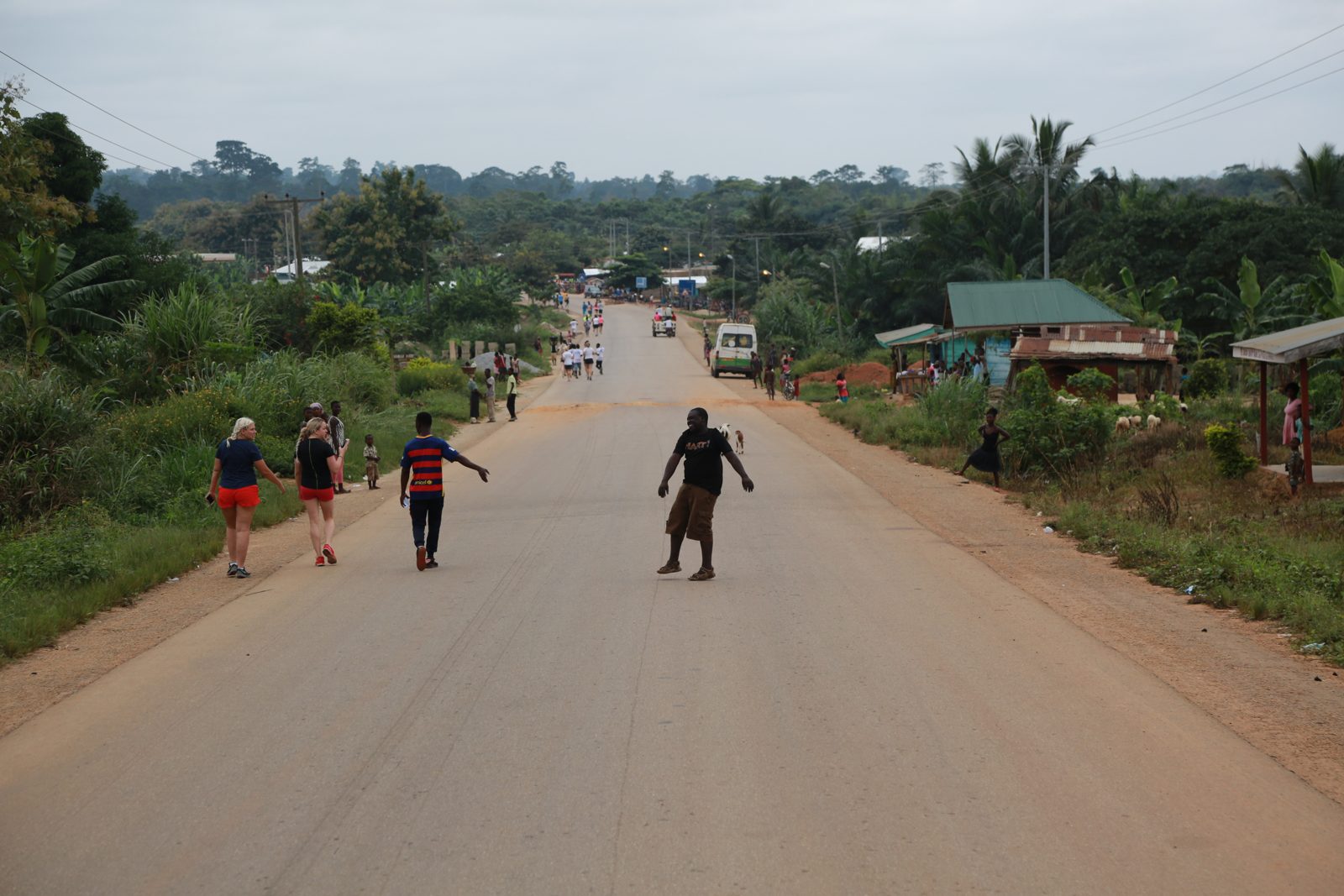 Runners heading away down the long village road