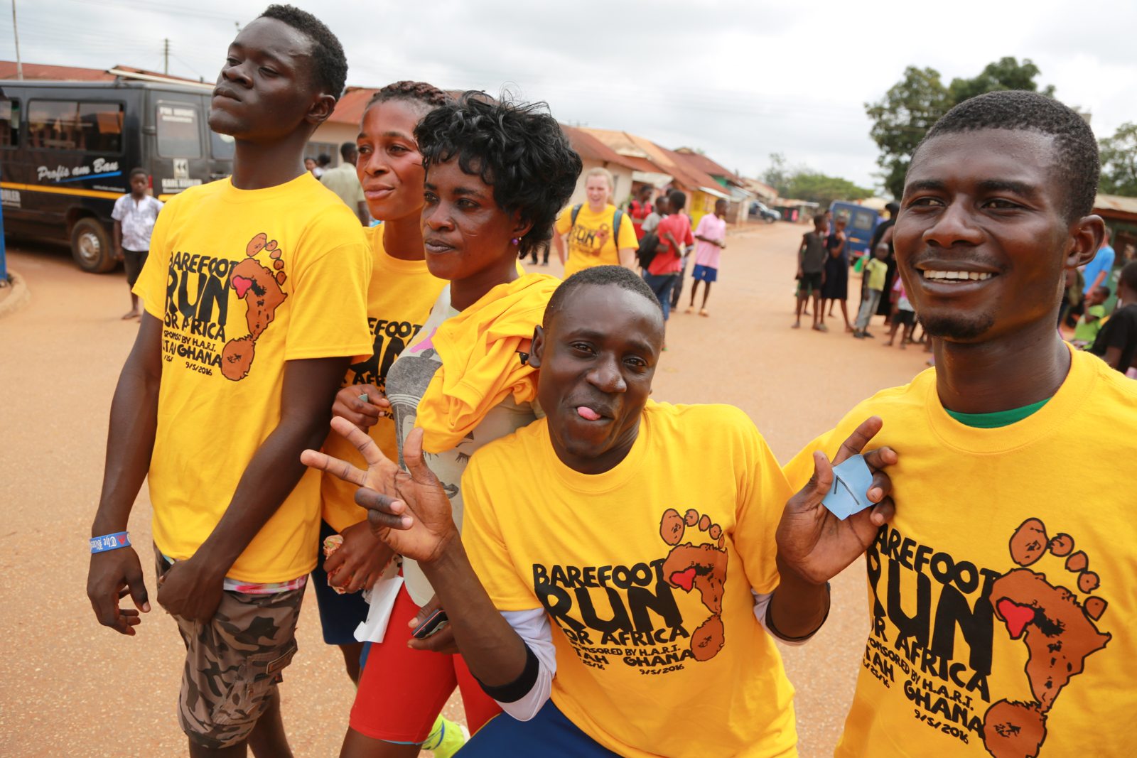 Runners in yellow Barefoot Run shirts laughing together