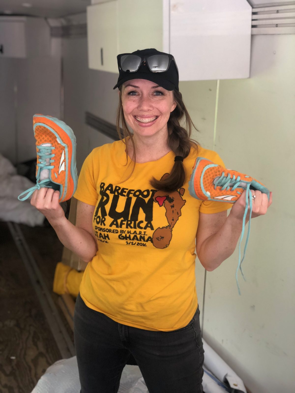 A volunteer holding a pair of sneakers