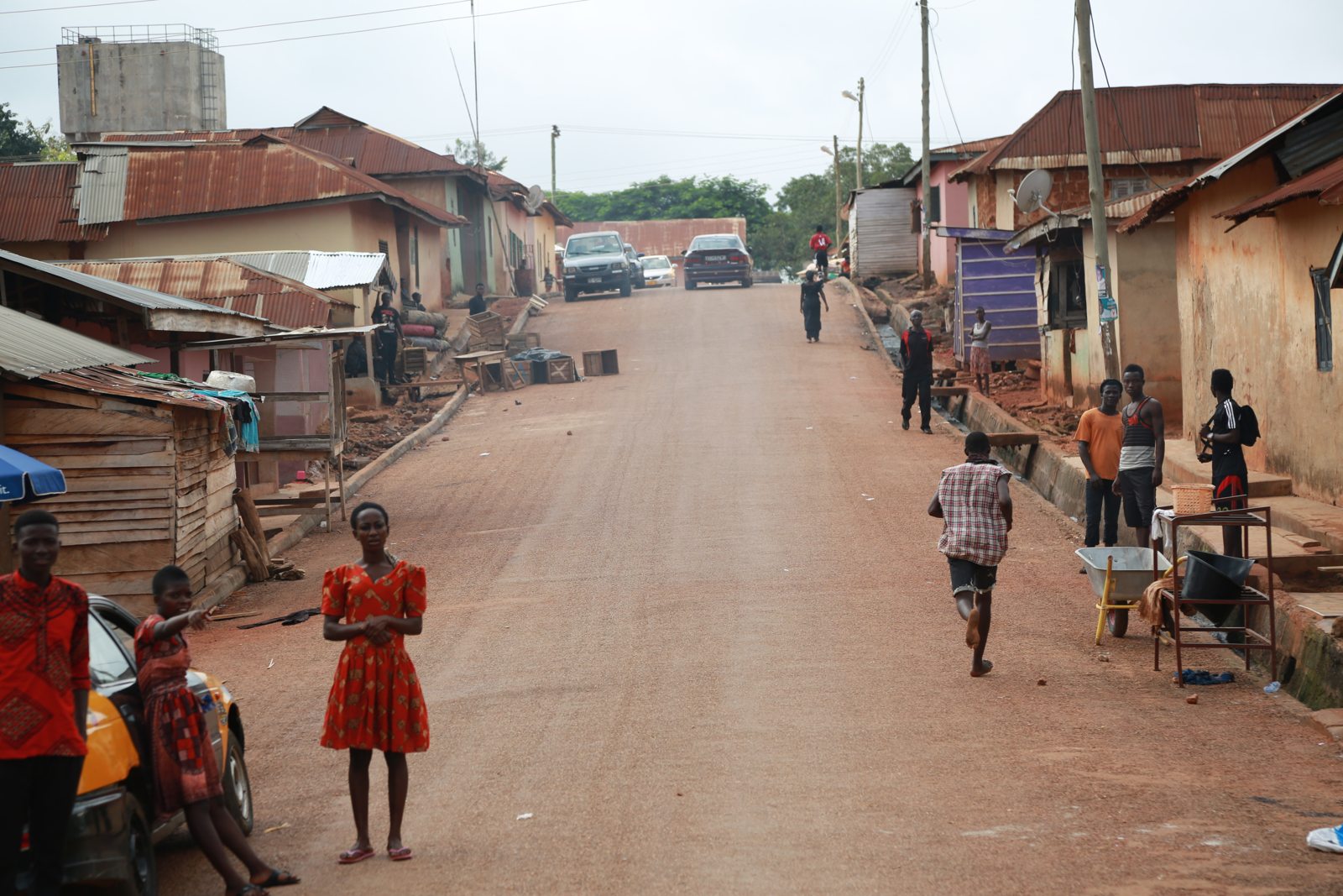 Children walking and running along the village street on race day