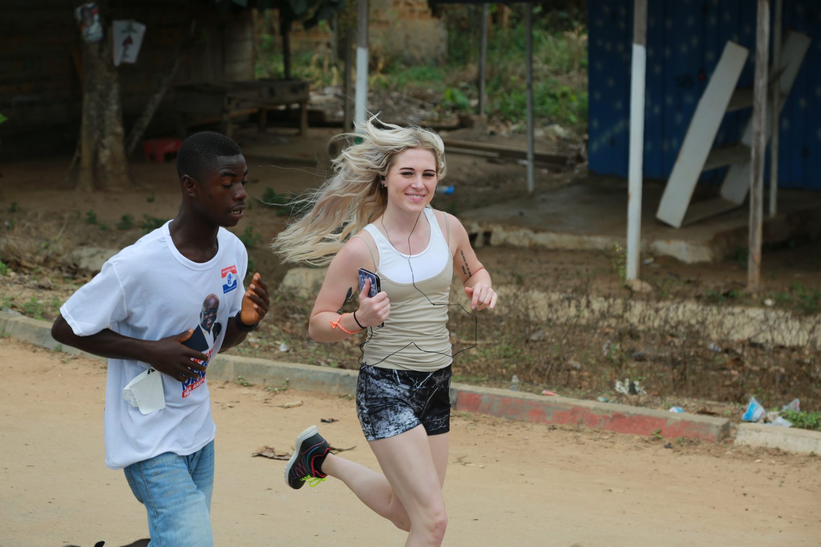 A volunteer and a local teen running stride for stride