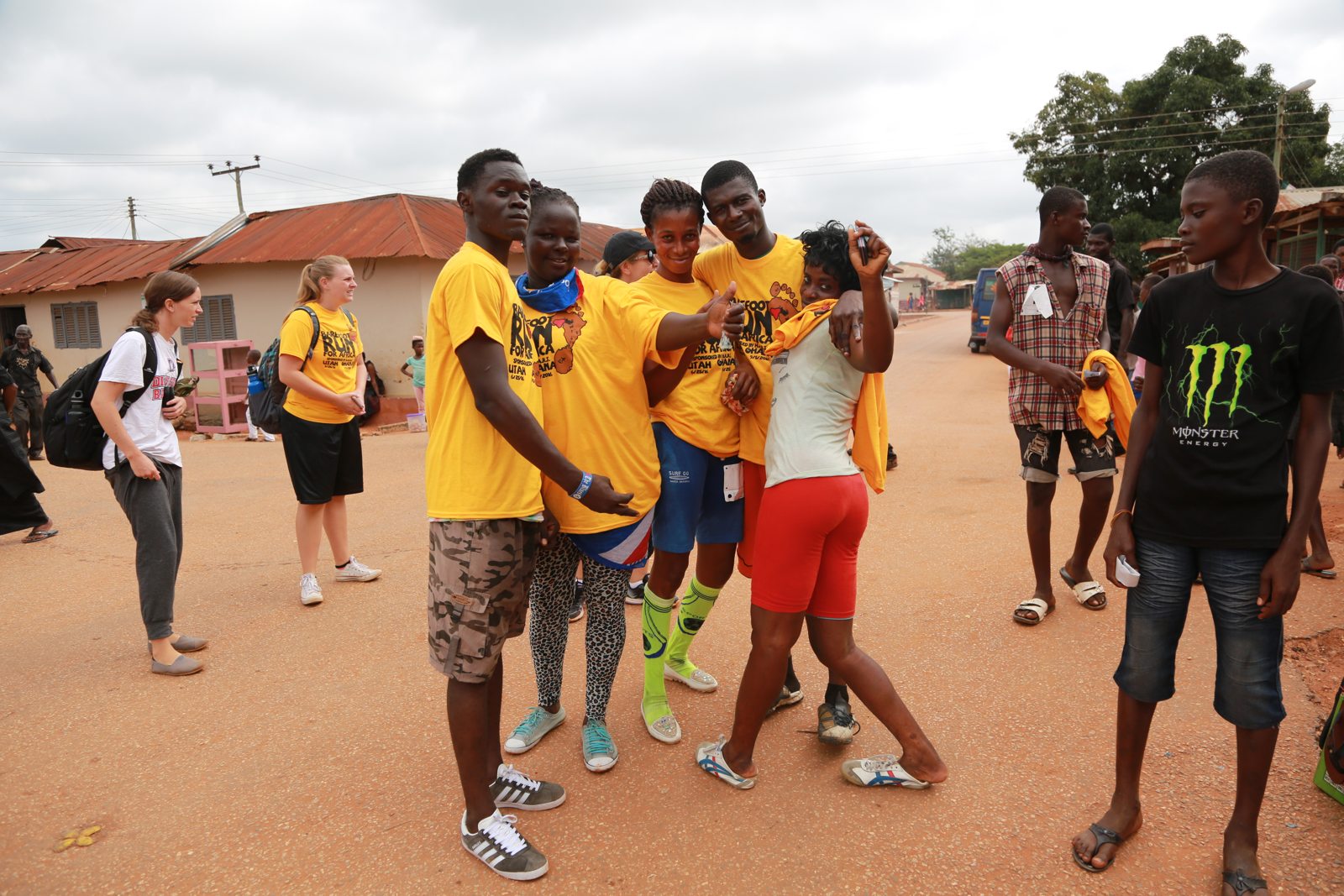 Teenagers in race shirts clowning together on the road