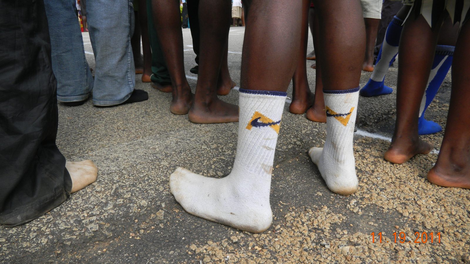 Bare feet and socks toeing the chalk start line