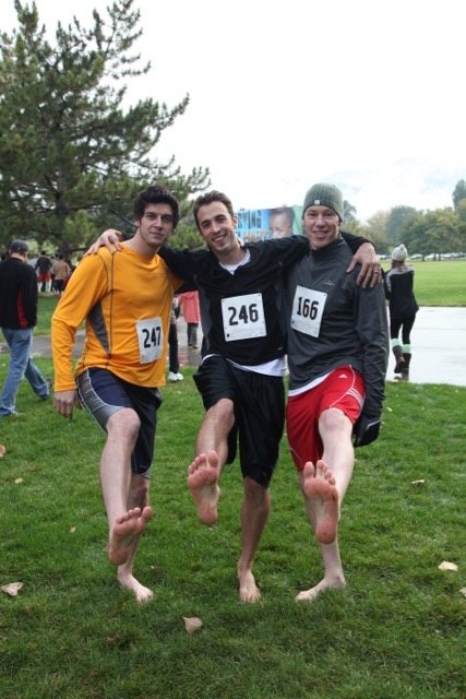Three runners showing off their bare feet before the race